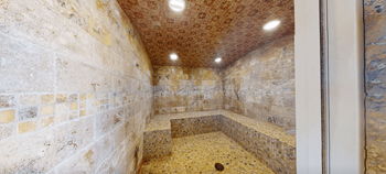 Indoor spa with cascading waterfall, steam room and cedar sauna